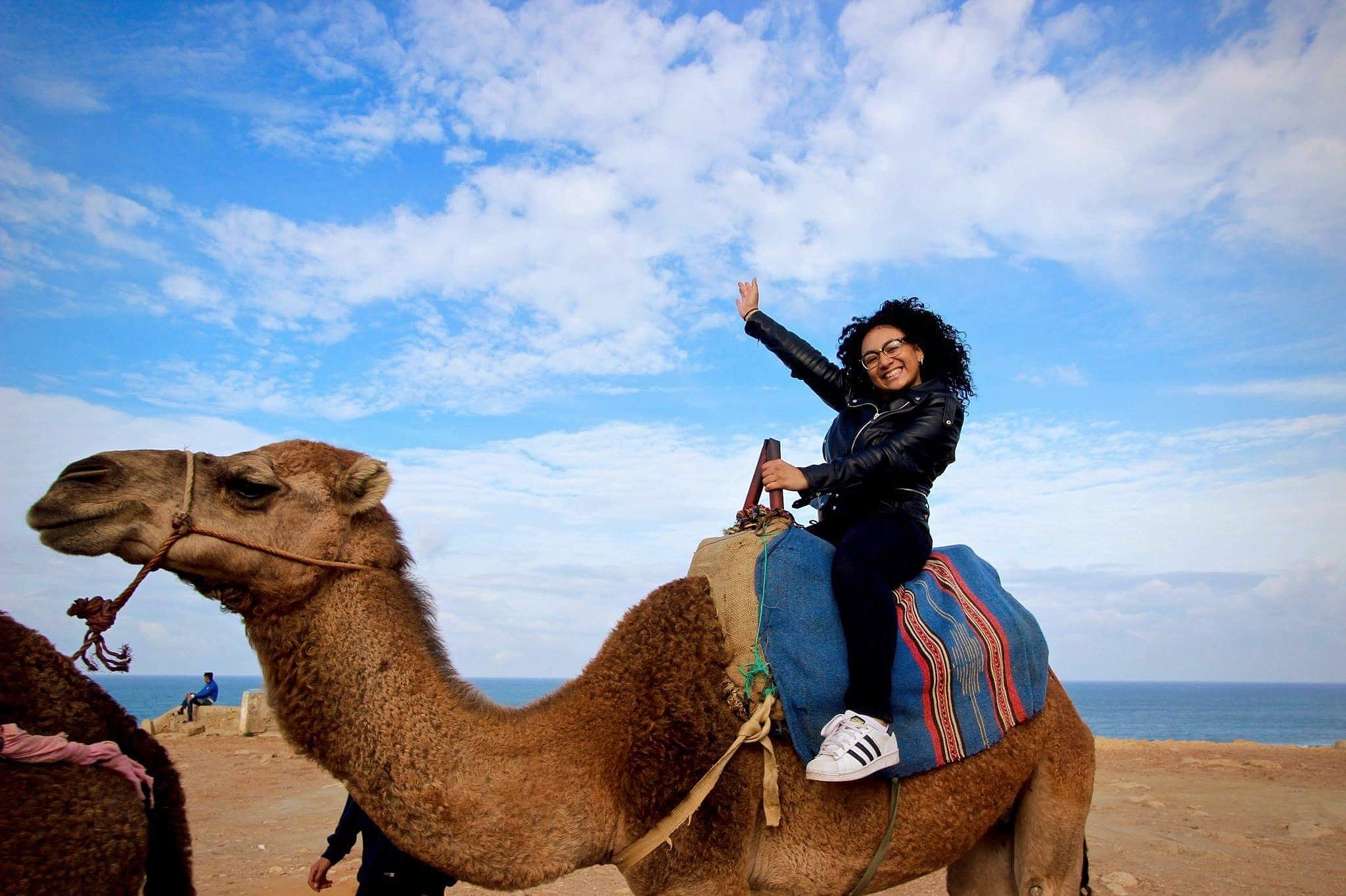 Student sitting on a camel.