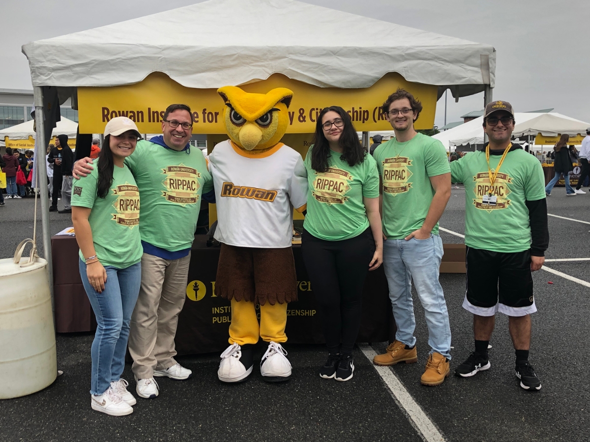 A group photos of Dr. Dworkin and RIPPAC students at Homecoming 2023