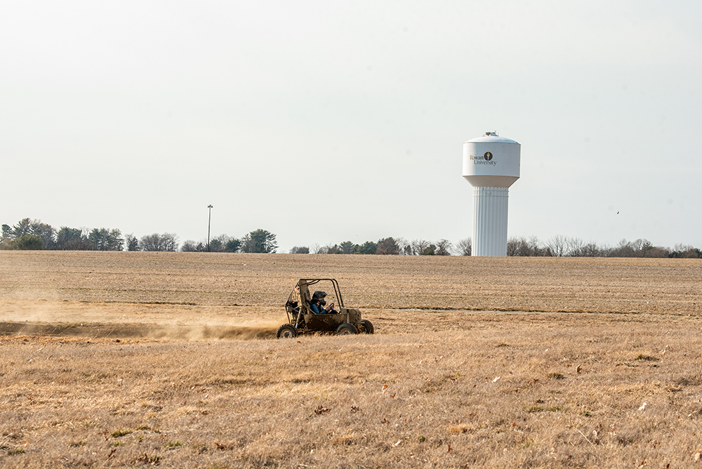 Rowan gokart on dirt in front of water tower