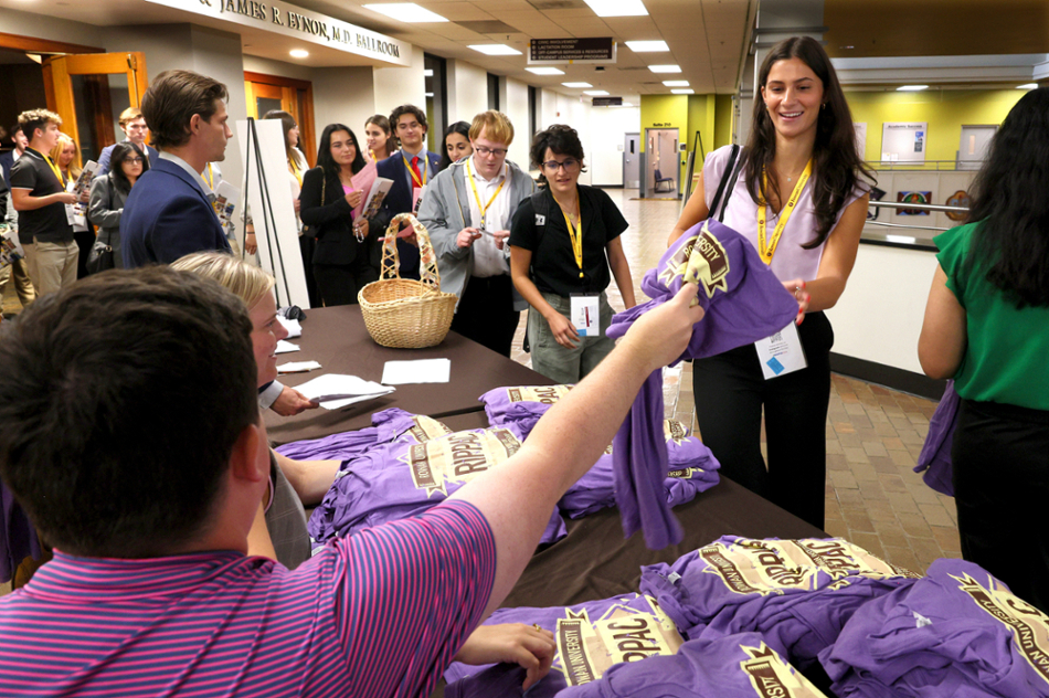 Attendees get their free T-shirts at MAPIS2024