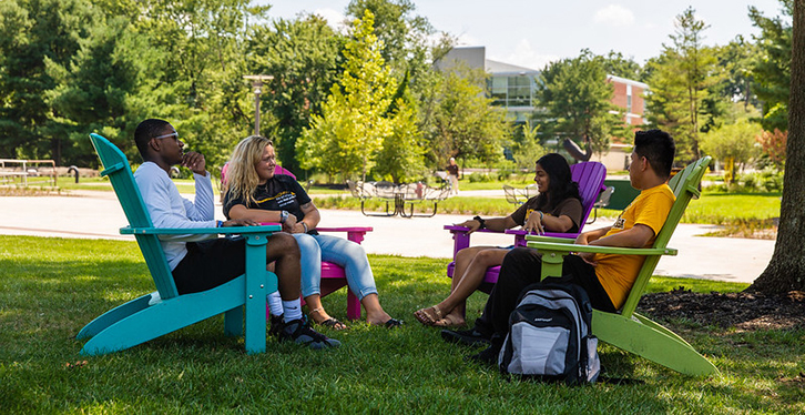 students sitting outside on chairs