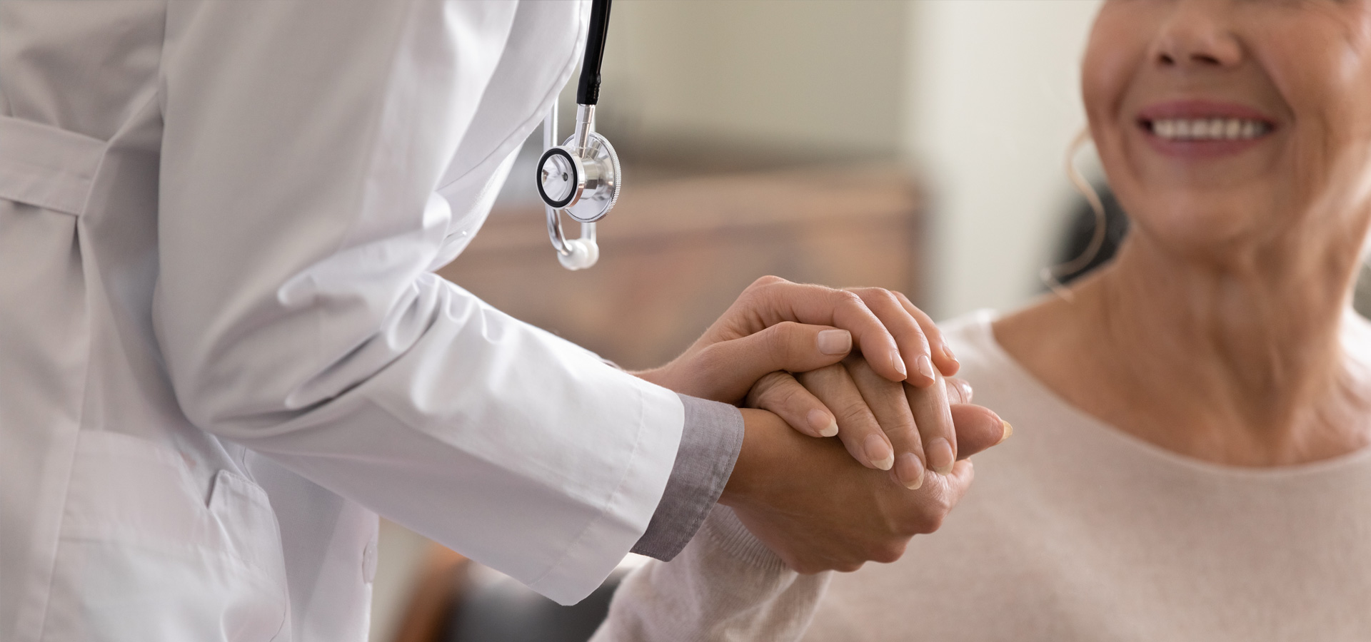 doctor holding the hand of a geriatric patient