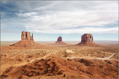 A desert landscape featuring three large sandstones buttes