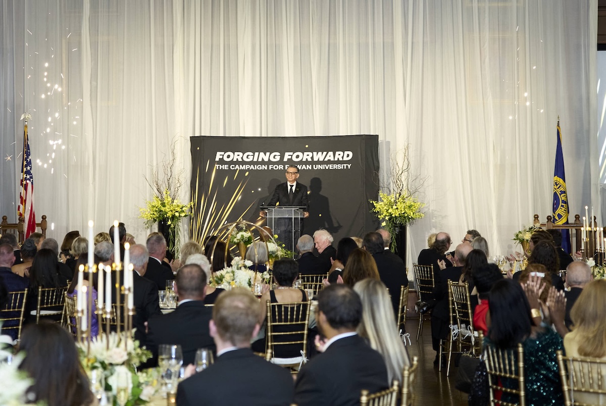 Dr. Houshmand standing at a podium at a Forging Forward event.