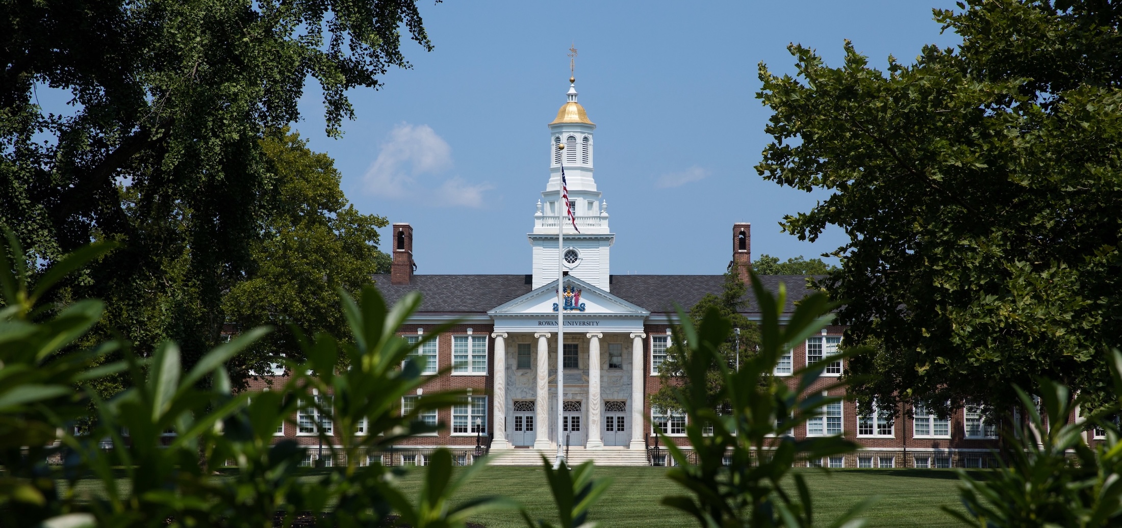 Rowan University Bunce Hall through the trees.