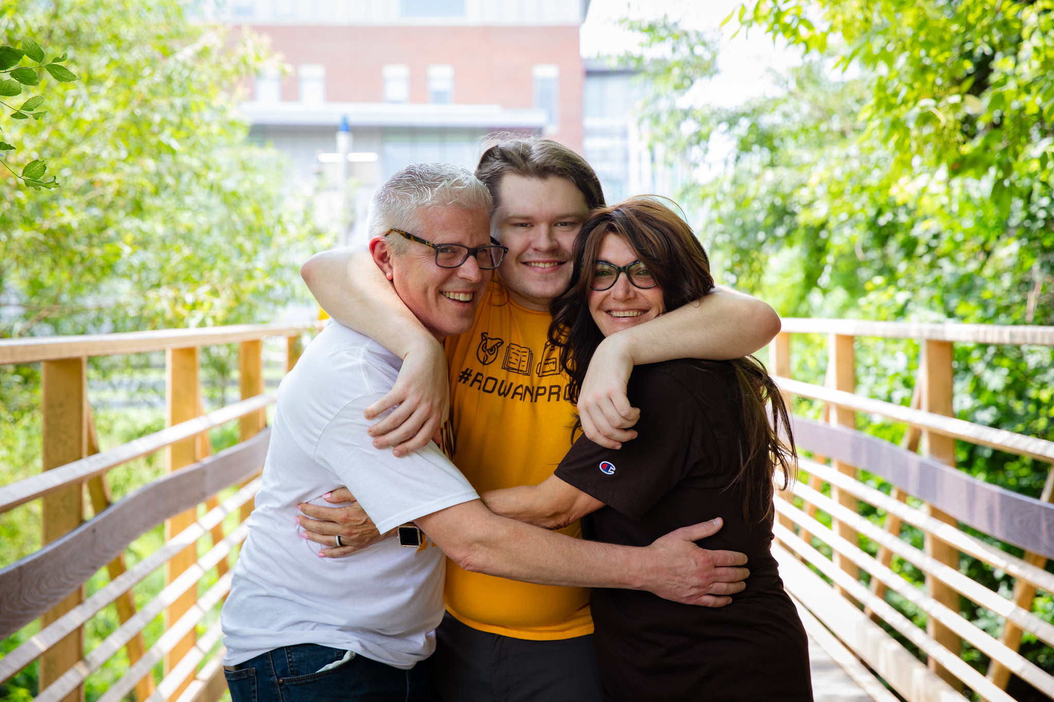 A Rowan Alum and his family hugging.