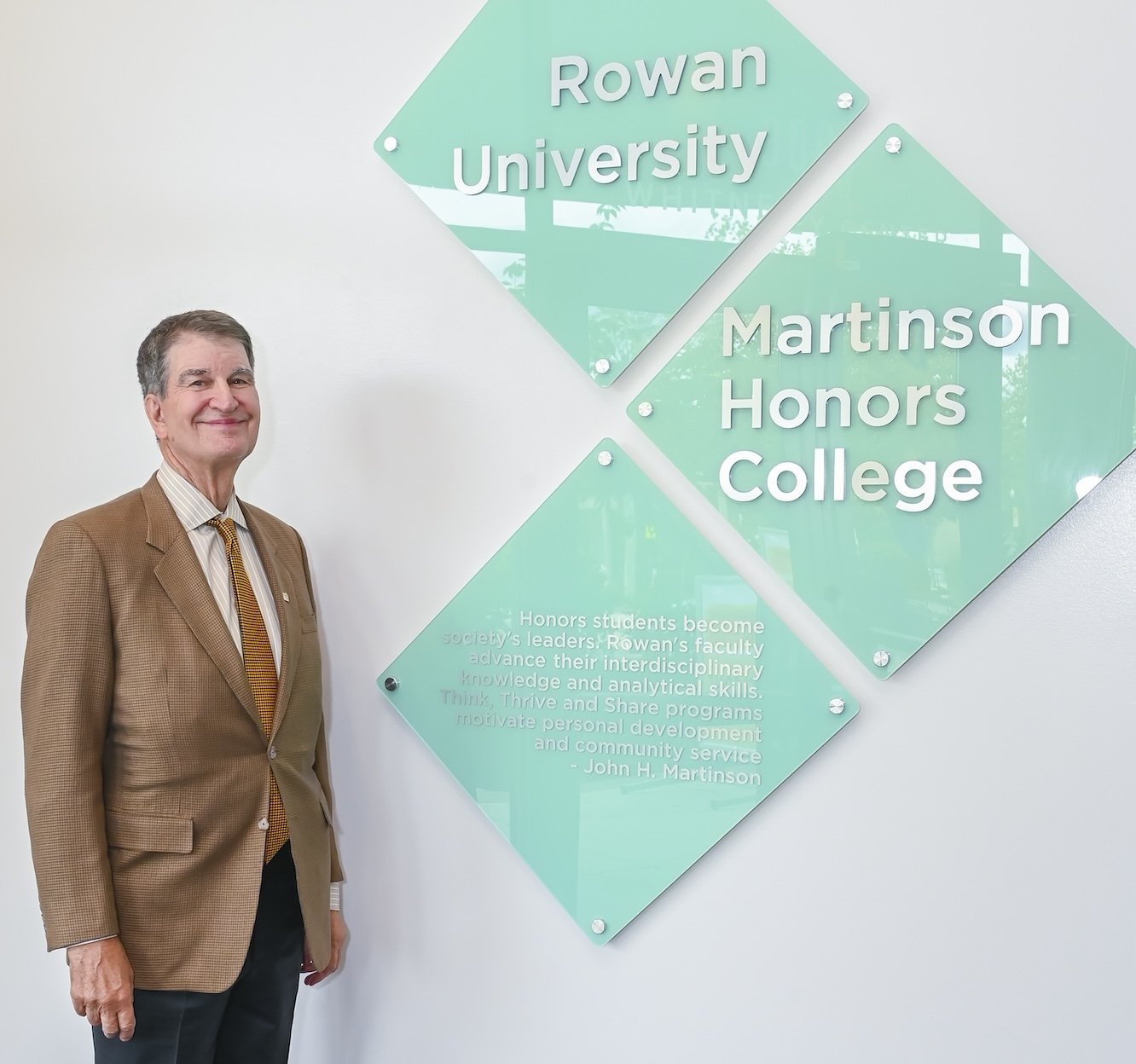 Dr. Martinson standing in front of the Honors College signage.