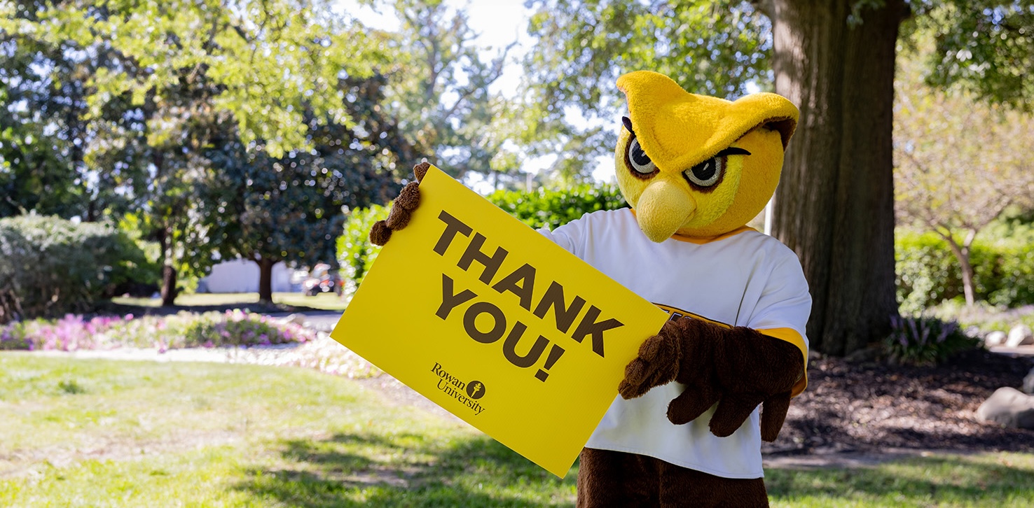 A photo of The Prof holding a "thank you" sign.