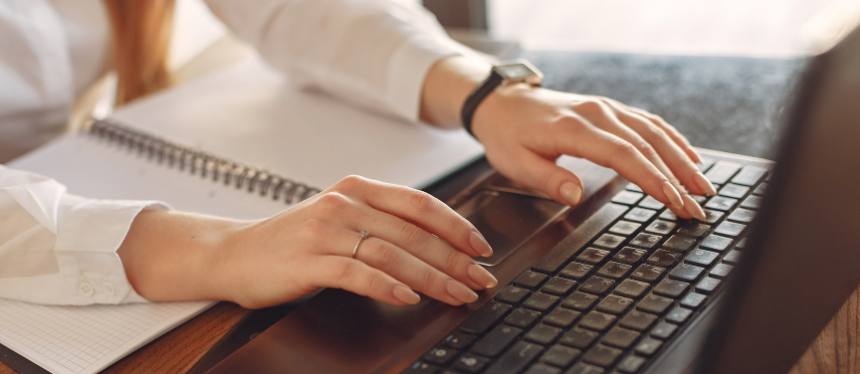 Image of hands typing on a laptop keyboard