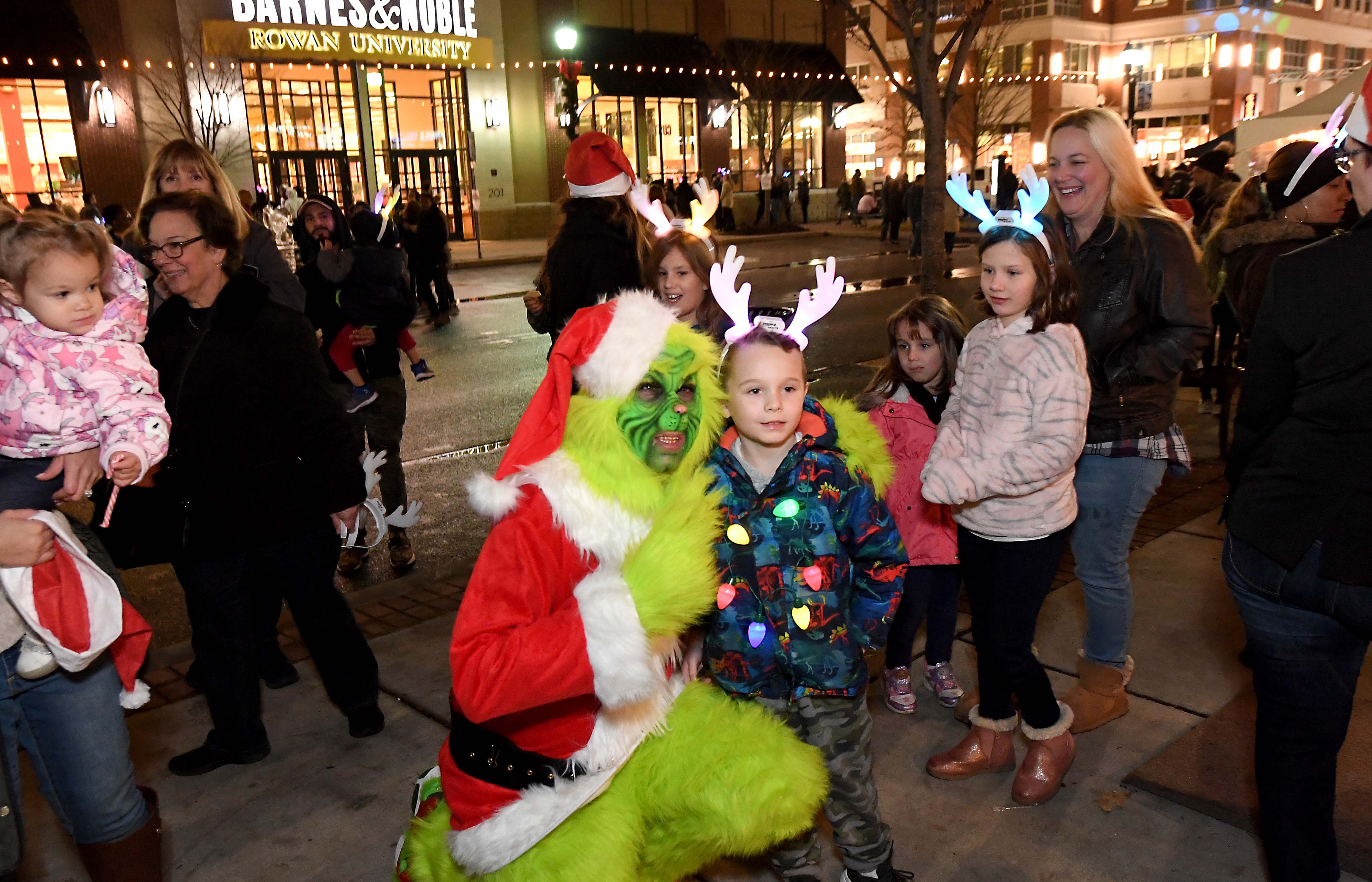 Community members pose with the Grinch as they celebrate the holiday season at the Annual Boro in Lights
