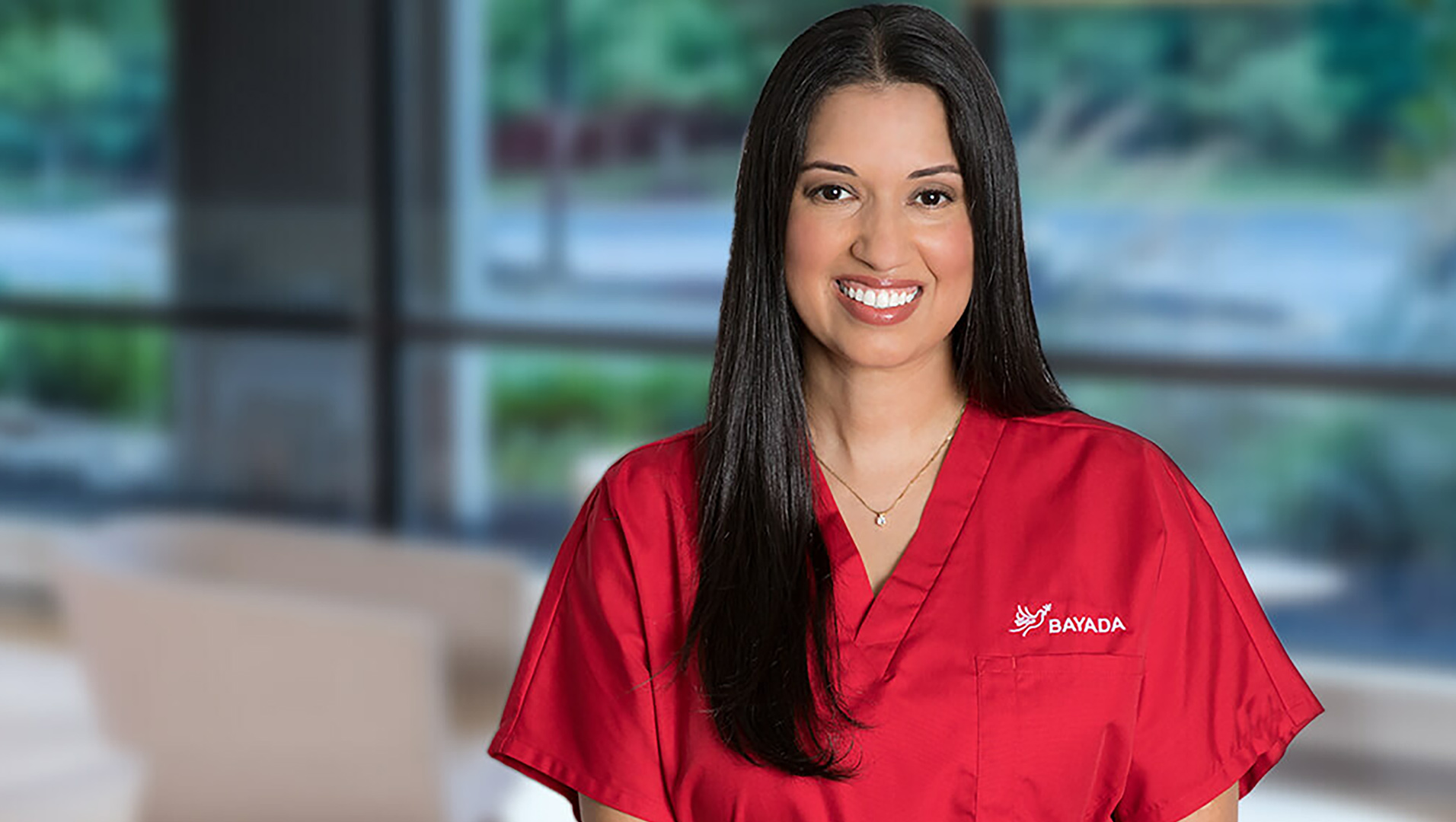 smiling Bayada nurse with red scrubs
