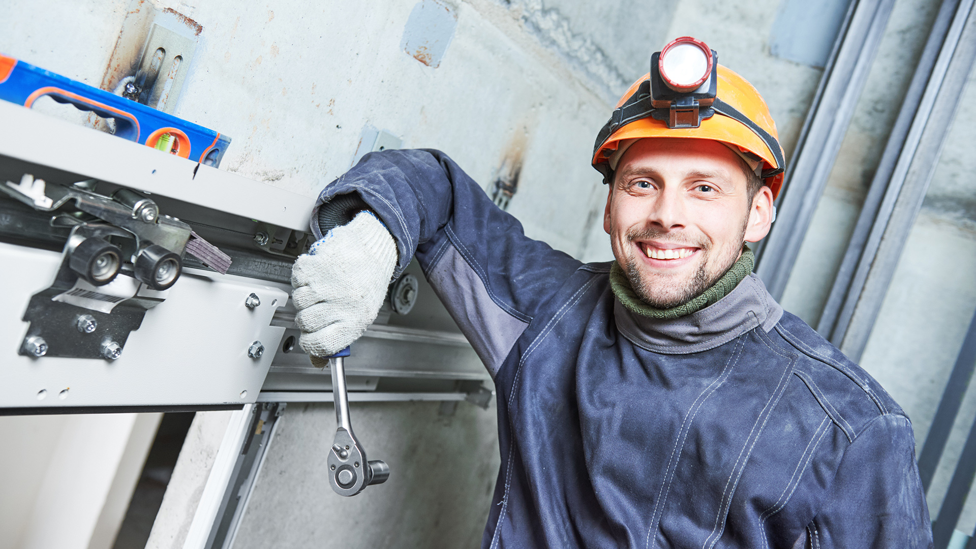engineering working on elevator with wrench