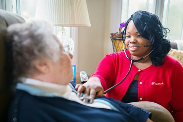 nurses discussing details on laptop
