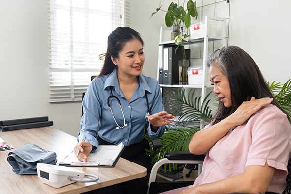 nurse examining geriatric patient