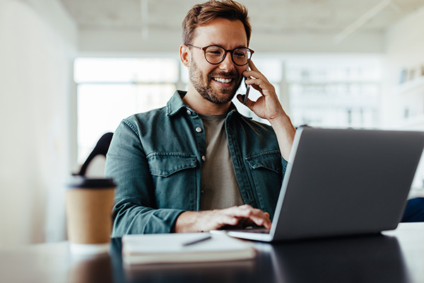 person on a call with a laptop smiling