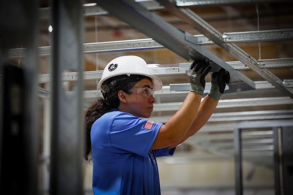 Construction worker using wood planer