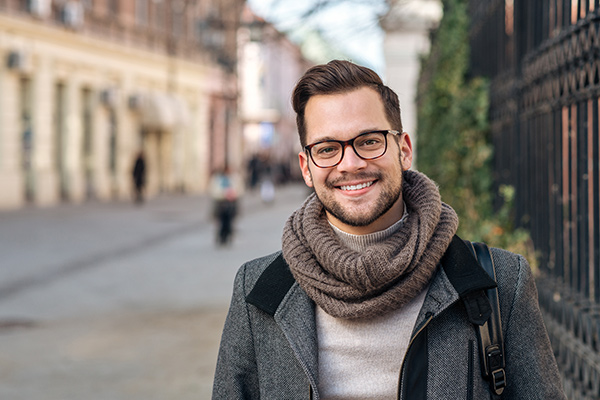 student with glasses smiling
