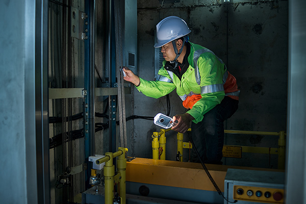 Construction worker using wood planer