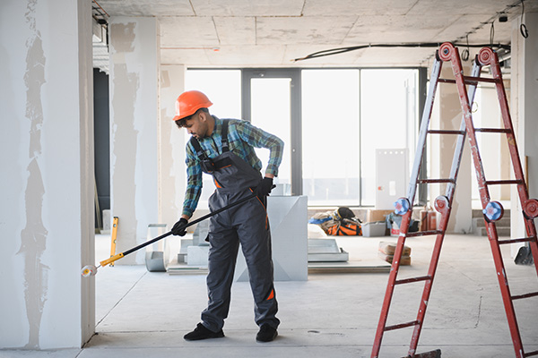 construction manager on tablet with building behind