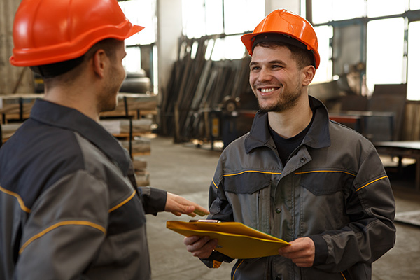 construction manager on tablet with building behind