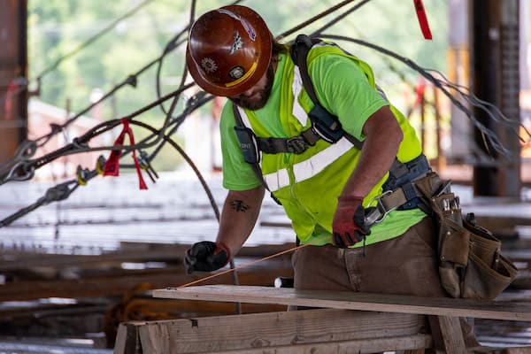 construction worker leaning over table