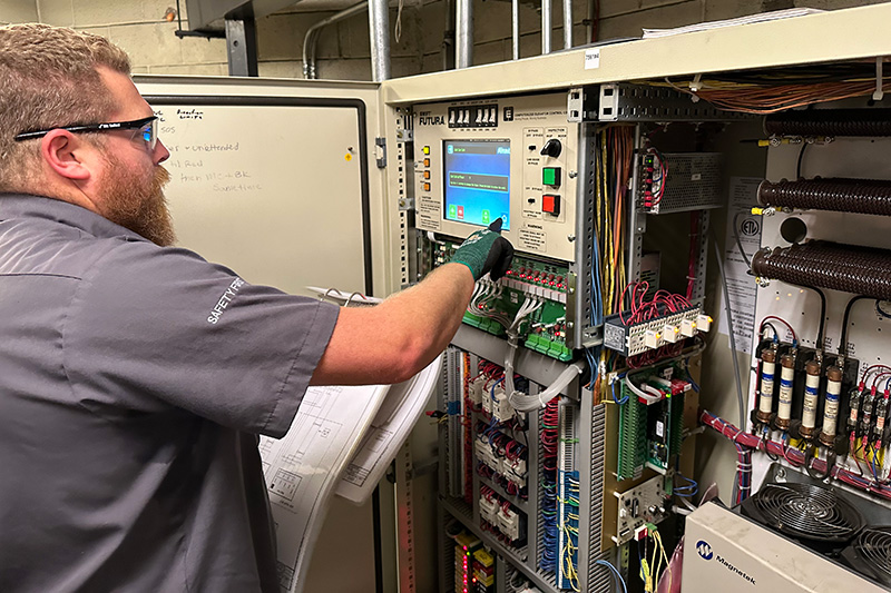 engineer inspecting elevator panel