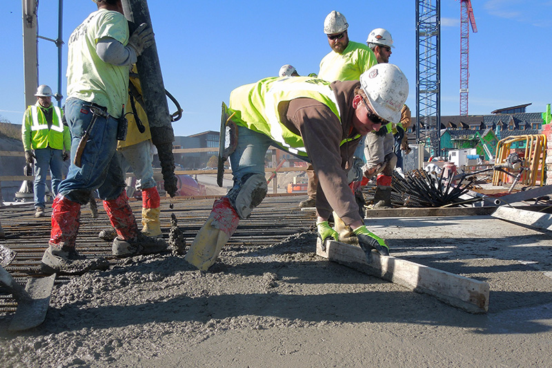 mason ensuring brick wall is level