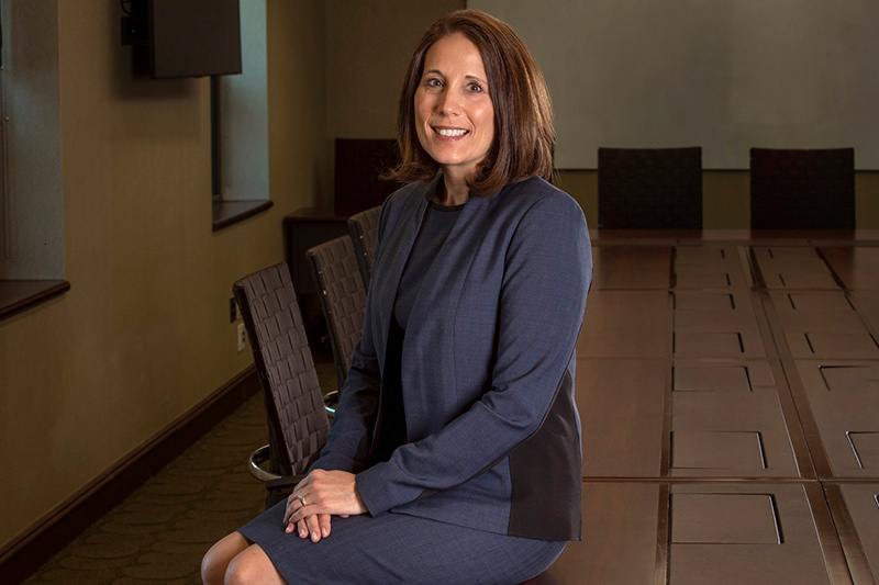 Cedar wang smiling, sitting in executive office 