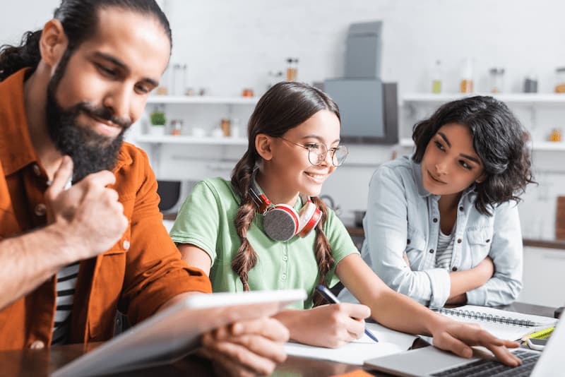 family at table with laptop