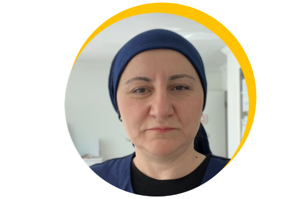 nursing student smiling, standing in front of building