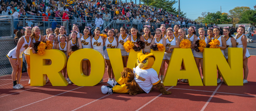 Homecoming Banner Image of cheerleaders with the Prof