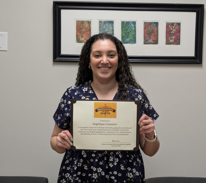 Angelique Gonzalez holding Prof of the Month Certificate