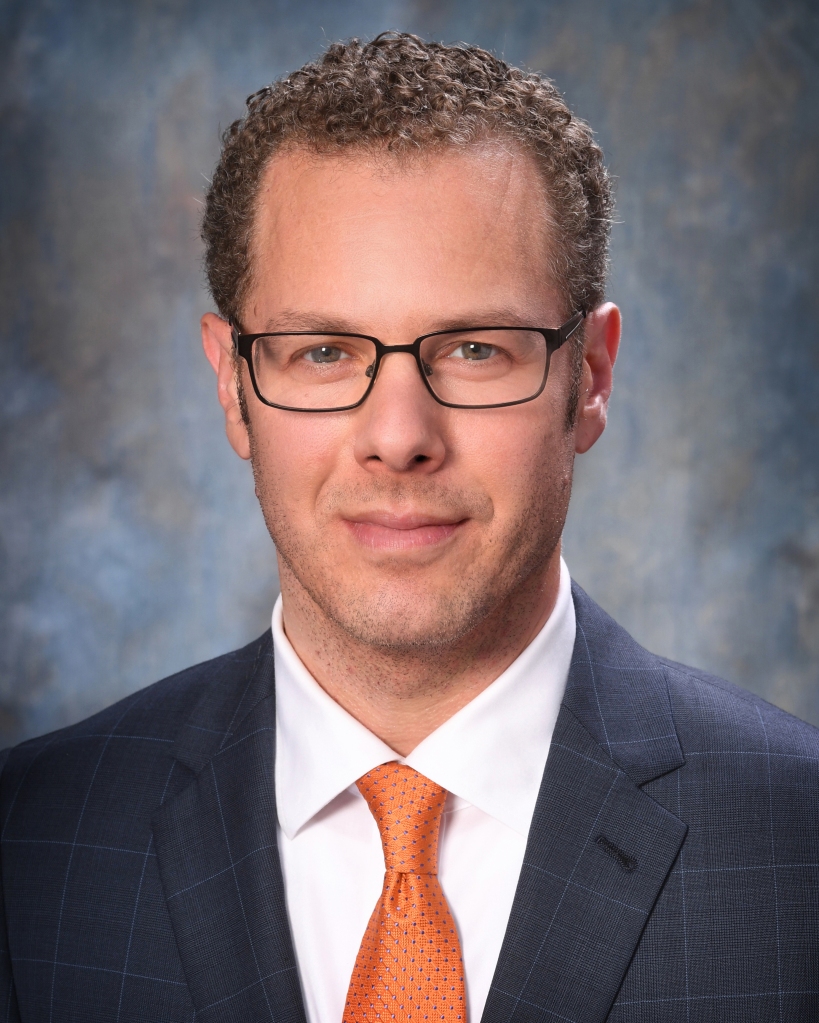 Jeff Bonfield smiling in a suit 