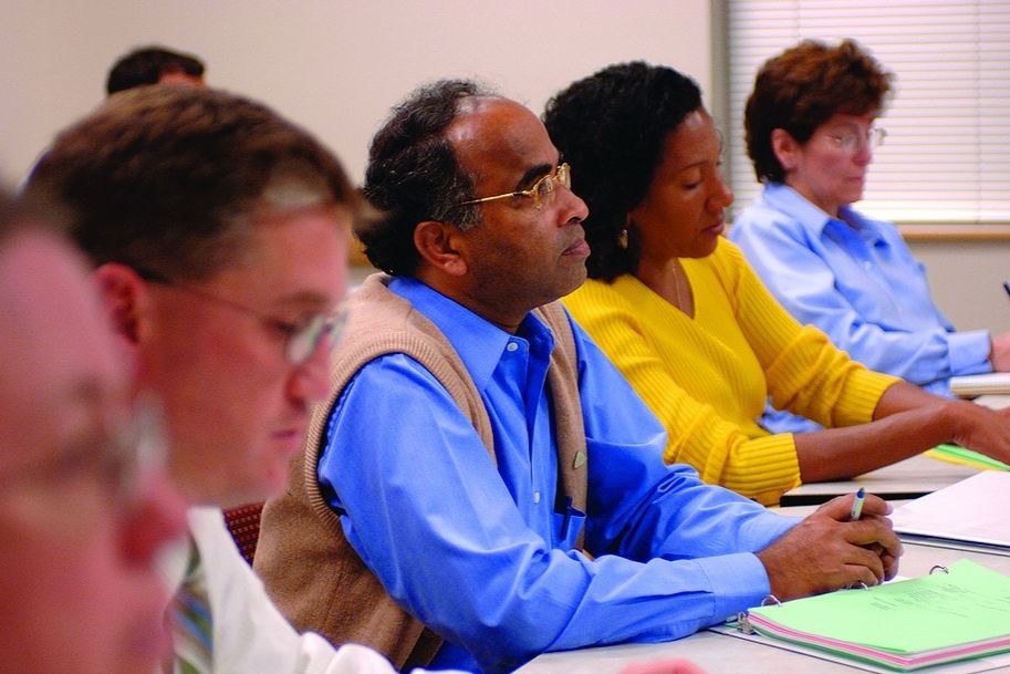 A diverse group of men and women in a classroom