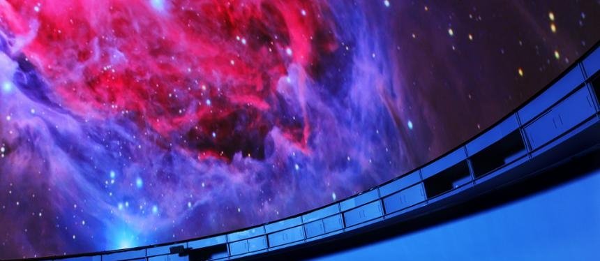 A nebula is projected on the planetarium's dome screen.
