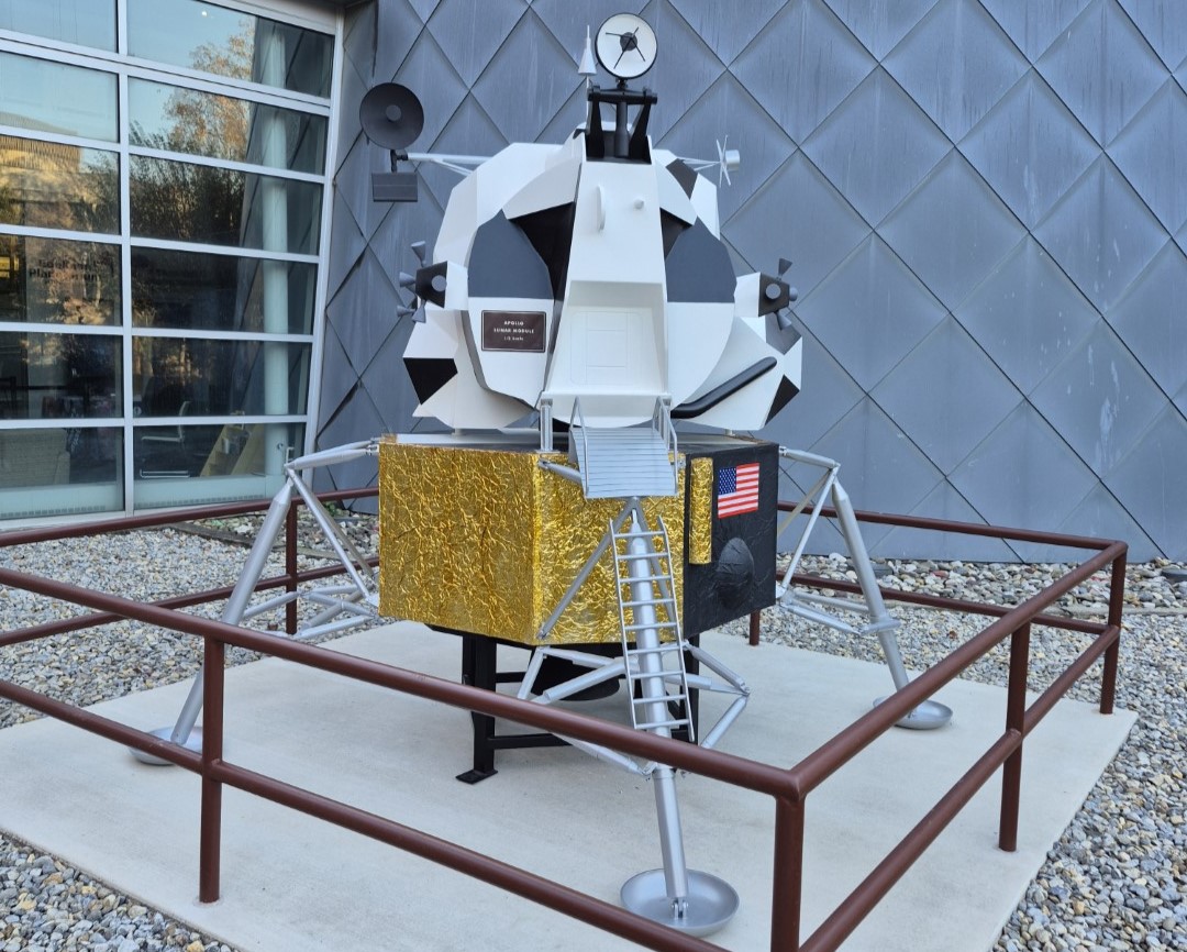 A 1/3-scale model of the Apollo Lunar Lander sits in front of the Edelman Planetarium