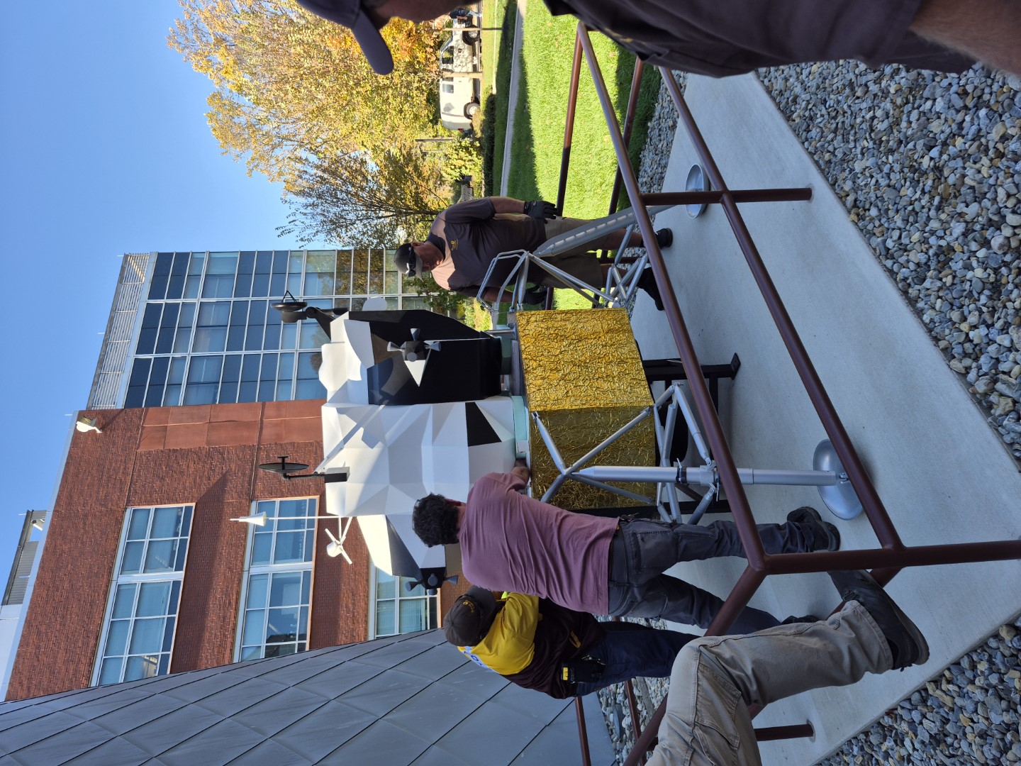 The top piece of the lander model is bolted into position.