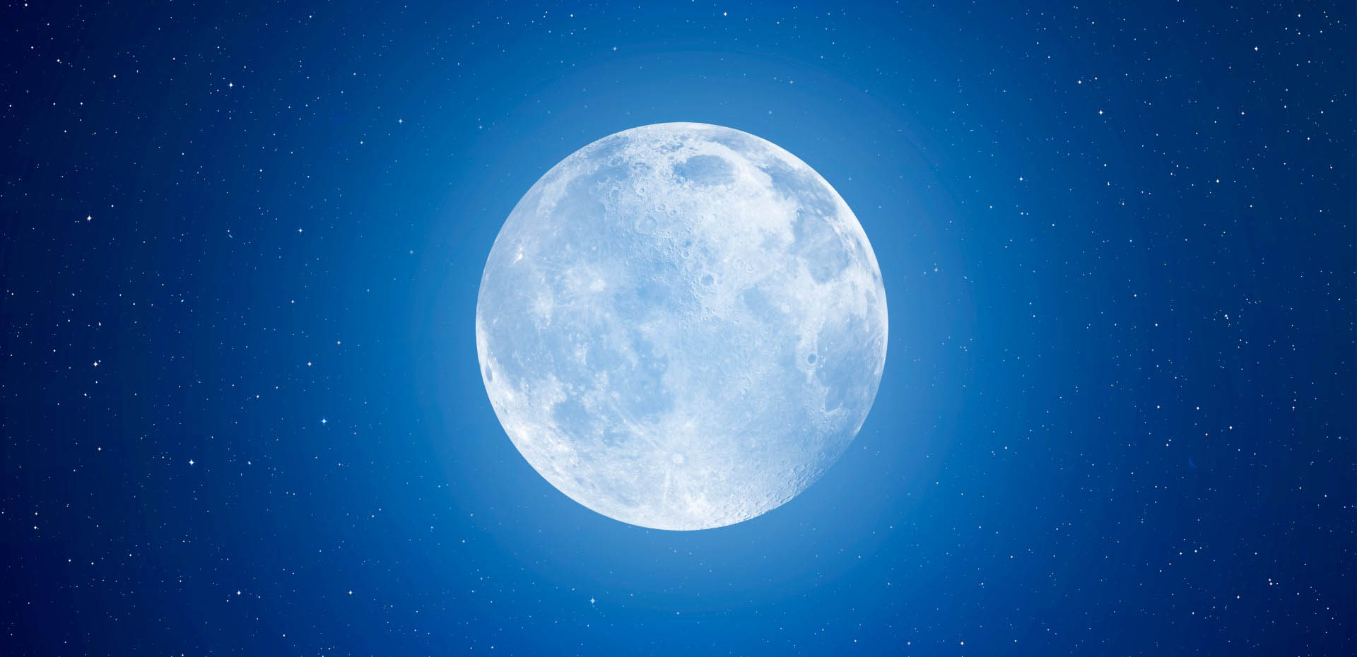 The full Moon glows against a background of stars.