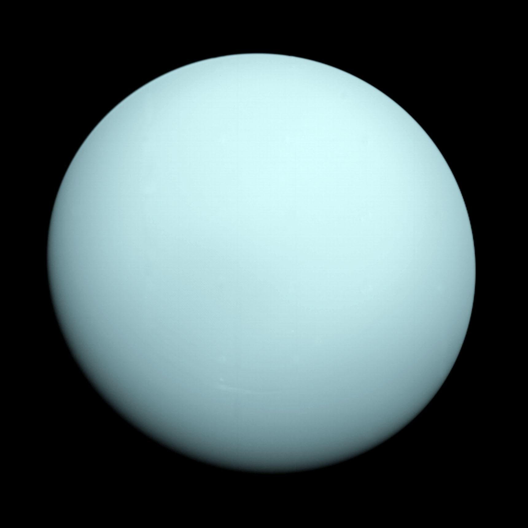 A view of Uranus from NASA's Voyager 2 spacecraft. The blue planet looks hazy with no discernable details.