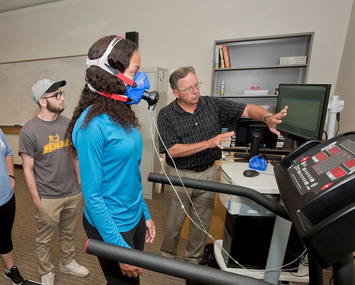 a faculty member monitors a student on a treadmill