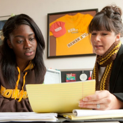 Students meet with an academic advisor to review materials and discuss their academic progress.