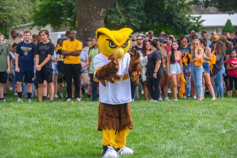 Prof mascot standing in front of students.