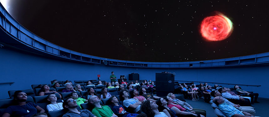 planetarium attendees viewing the sky presentation