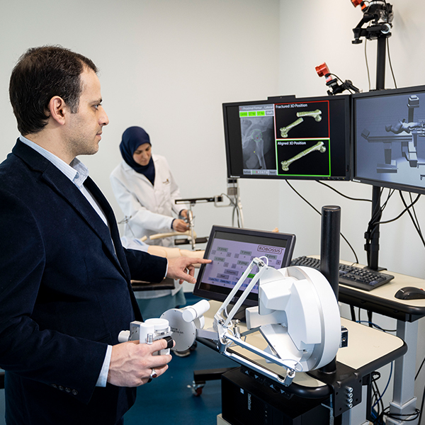 a researcher works with a robotic device for long bone research