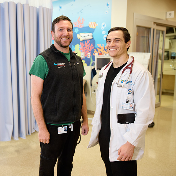 a Virtua/CHOP doctor poses in the pediatric ward with an SOM student doctor
