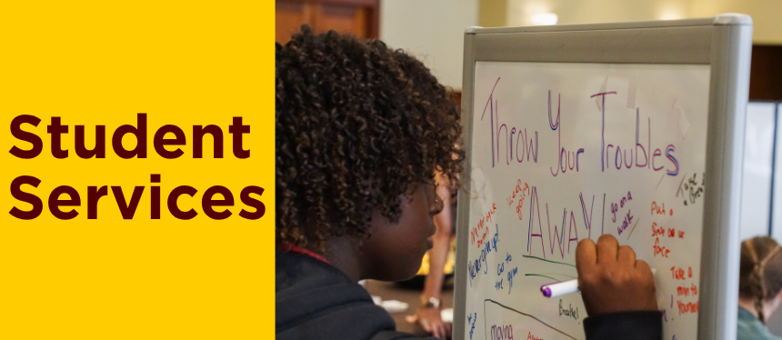 a student writing on a whiteboard answering the prompt: "throw your troubles away."